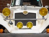 a close up of a white car with yellow lights