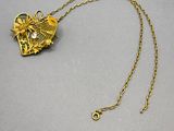 an image of a gold necklace with a dragon on it
