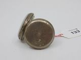 a small silver pocket watch with a tag on it