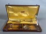 a wooden box with a set of silverware in it