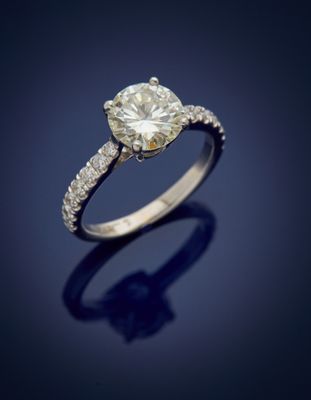 a close up of a diamond ring on a blue background