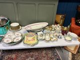 une table sur laquelle se trouvent beaucoup d'assiettes et de bols