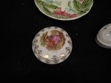 two plates with flowers on them sitting on a table