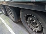 a truck that has a flat tire on the side of the road