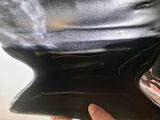 someone is holding a black purse with a zipper on it
