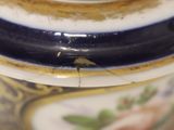 a close up of a vase with a bird on it
