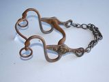 a pair of scissors on a chain on a table