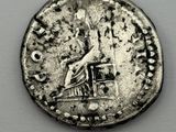 an old silver coin with a statue on top of it