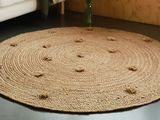 a round rug on the floor in a living room