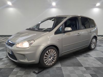 a picture of a silver car parked in a showroom