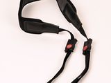 a black strap that has a red button on it