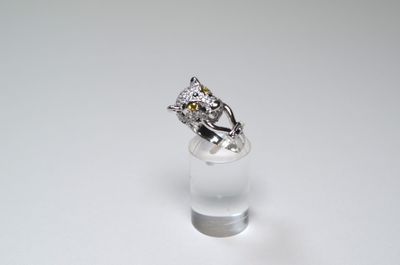 a ring that is sitting on top of a clear glass
