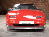 an image of a red sports car parked in a garage