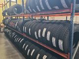 tires are stacked up on a rack in a warehouse