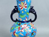 a blue vase with a floral design on it
