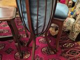 two chairs and a table on a rug in a room