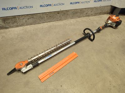 a close up of a corded hedger on the ground next to a piece of orange tape