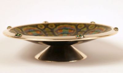 a bowl with a design on it sitting on a stand