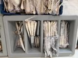 many forks and spoons in a plastic container