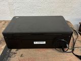 a black laptop computer sitting on top of a wooden table