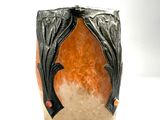 an image of a vase with a bat design on it