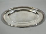 a silver plate with a beaded edge on a table