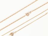 a set of three gold chain necklaces on a white background