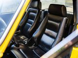 a yellow car with black leather seats in the back of it