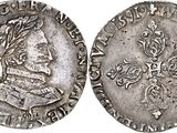 a silver coin with an image of a man on it
