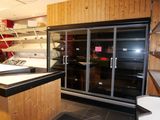 a glass display case in the middle of a kitchen