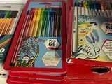 many different colored pencils in a box on a shelf
