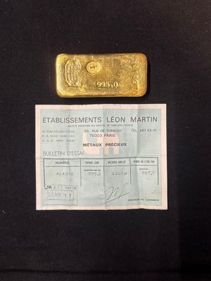 gold bar on a black background with a receipt for a gold bar