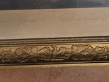 a picture of a gold frame with a picture on it
