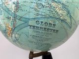 a globe on a stand that has a map on it