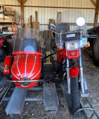 a red motorcycle with a side car attached to it