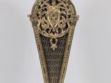 a gold clock on a stand on a white background