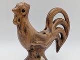 an image of a wooden rooster figurine on a white background