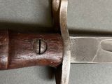 a close up of a knife with a wooden handle