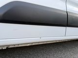 a close up of a white van with a black stripe