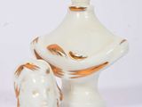 a white vase with a brown and white design on it