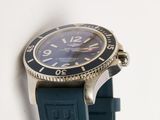 a watch that is sitting on a blue strap