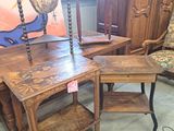 a table with a lamp on it and a chair in front of it