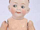 a small doll that is sitting on a white surface