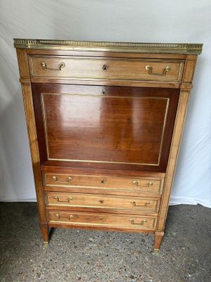 an image of a wooden cabinet with drawers on top of it