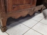 a wooden cabinet that is sitting on a tile floor