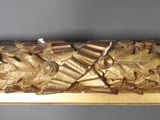 a gold sculpture of a fish on a gold plate