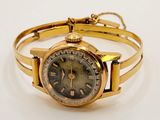 an image of a gold wrist watch with roman numerals on it