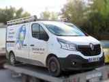 a van that is sitting on a flatbed truck