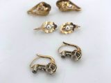 five pairs of gold earrings and a pair of silver earrings