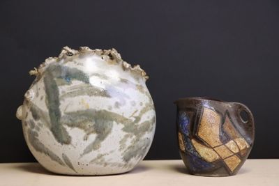 two vases sitting next to each other on a table